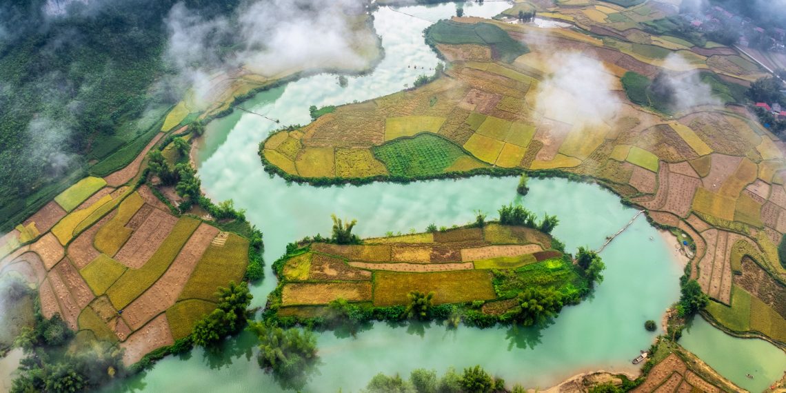 Vietnam Honored as One of the Most Beautiful Countries in the World 1 Aerial drone view of rice terrace paddle field around the river at Phong Nam, Cao Bang, Vietnam