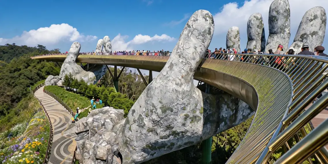 Ba Na Hills 2026: The Ultimate A-Z Travel Guide for a Perfect Trip 1 Golden Bridge Ba Na Hills Vietnam held by giant stone hands emerging from mountainside with clear blue sky