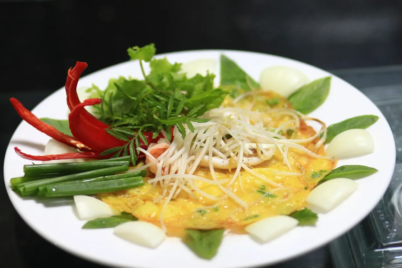 Da Nang Travel Guide 2026: 15 Best Things to Do, Itineraries & Insider Tips for Vietnam's Coastal Gem 12 Banh Xeo Vietnamese crispy pancake Da Nang with fresh herbs bean sprouts and dipping sauce
