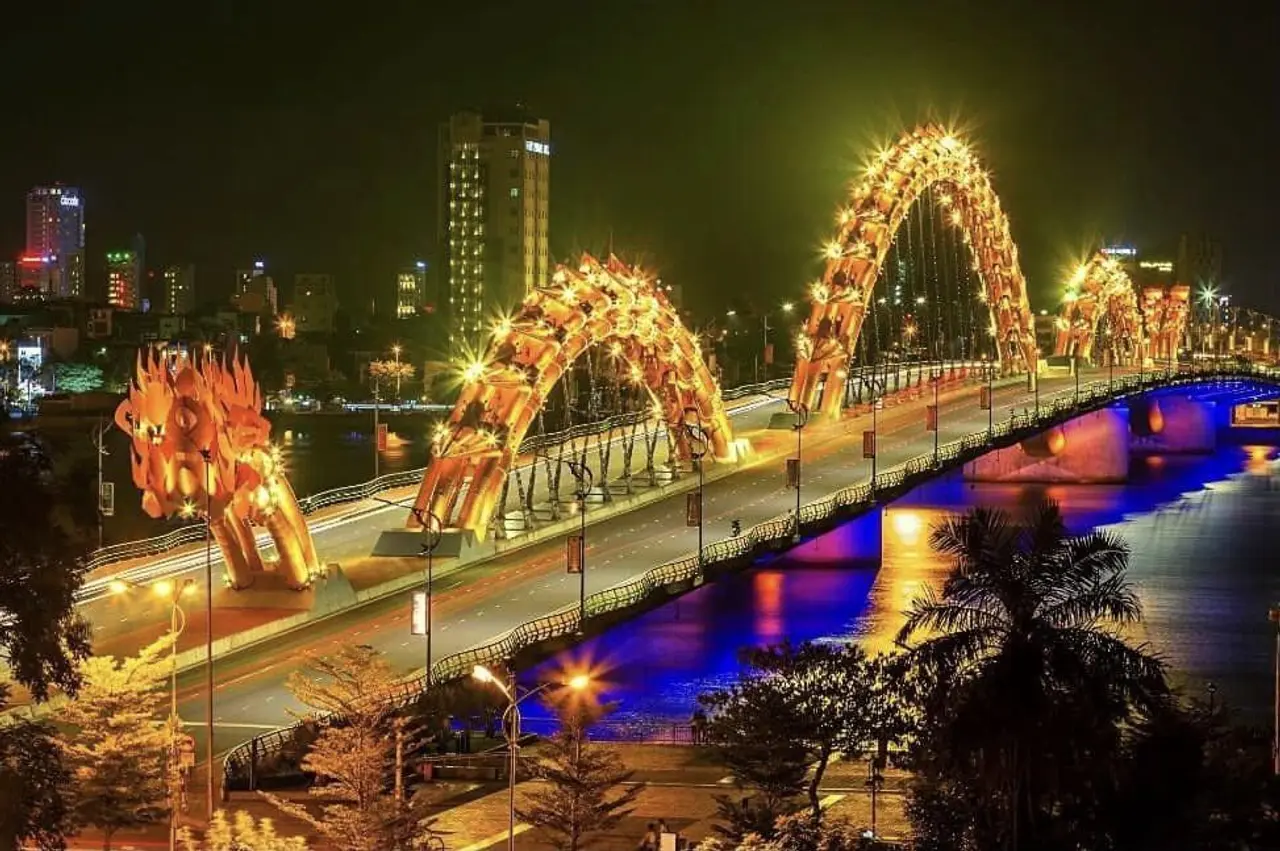 Da Nang Travel Guide 2026: 15 Best Things to Do, Itineraries & Insider Tips for Vietnam's Coastal Gem 9 Dragon Bridge Da Nang illuminated at night spanning the Han River with golden dragon structure